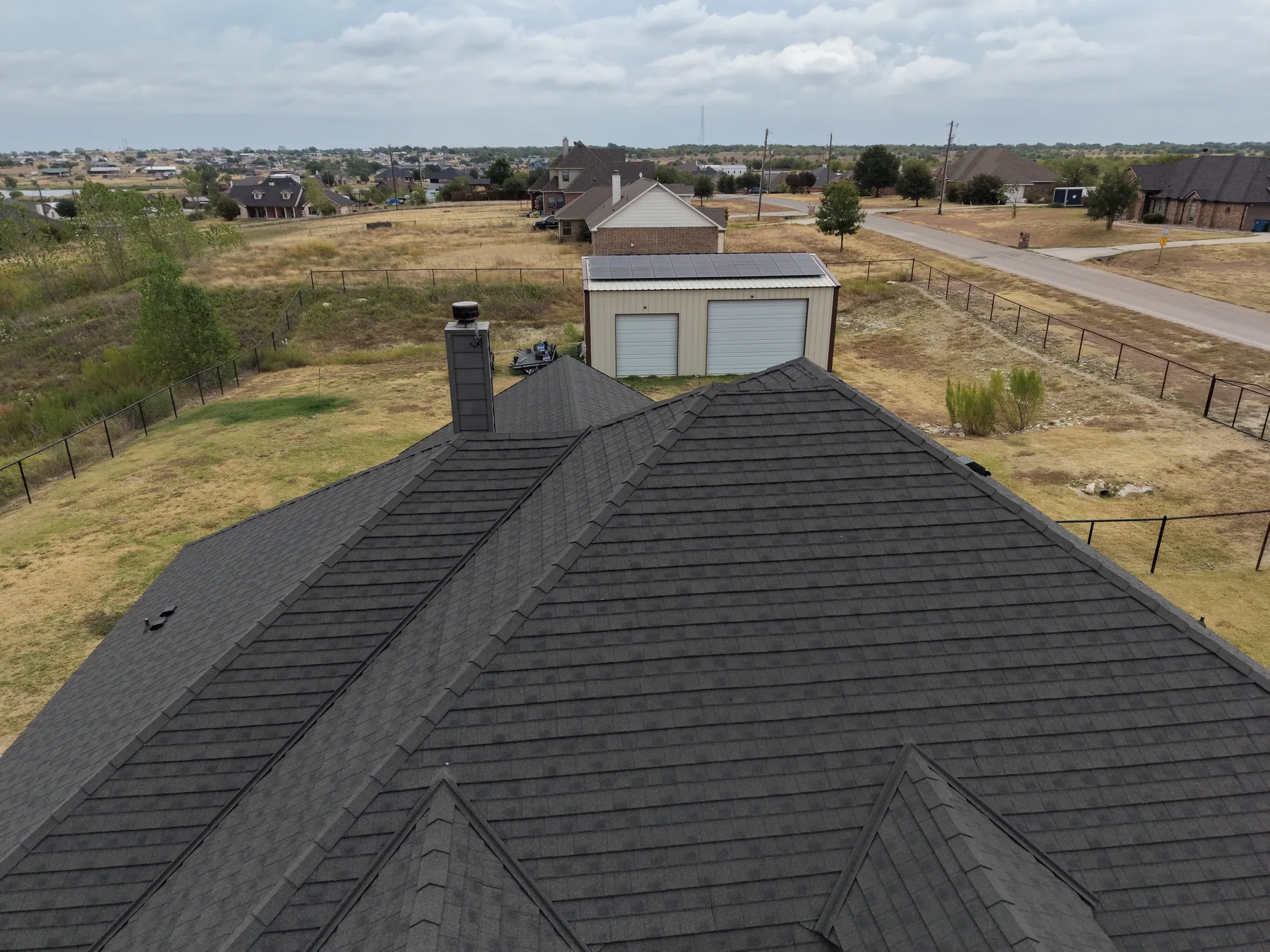 Weathered Wood Stormetal roof showing the ridge and layered shingle profile
